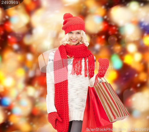 Image of teenage girl in winter clothes with shopping bags