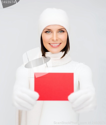 Image of woman in winter clothes with blank red card