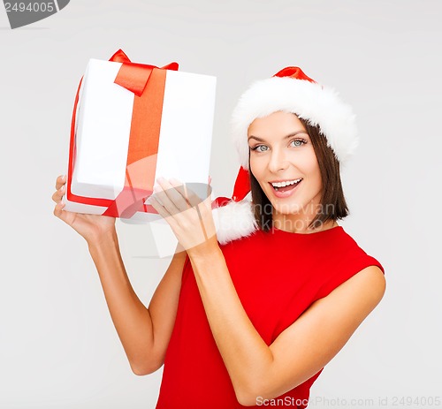 Image of smiling woman in santa helper hat with gift box