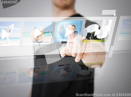 Image of man pressing button on virtual screen