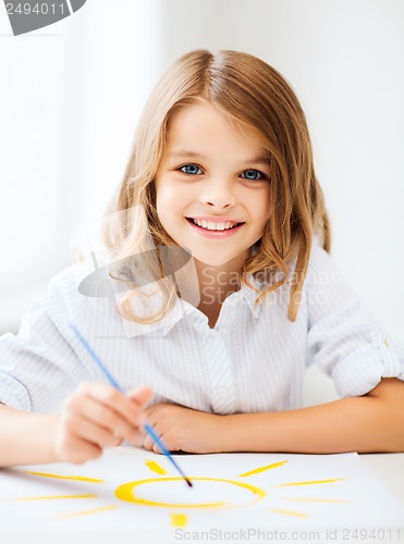 Image of little girl painting at school