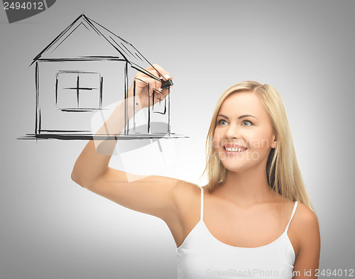 Image of woman drawing house on virtual screen