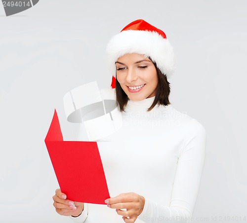 Image of woman in santa helper hat with blank red postcard
