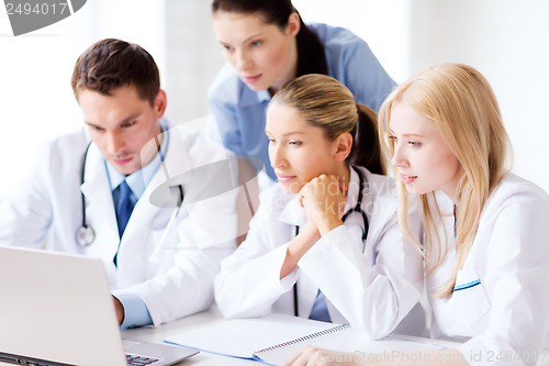 Image of group of doctors looking at tablet pc