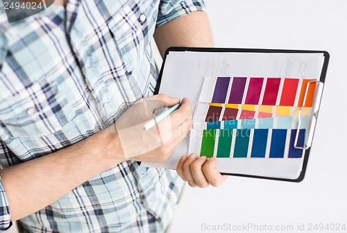 Image of man with color samples for selection