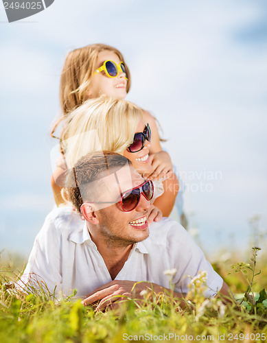 Image of happy family with blue sky and green grass