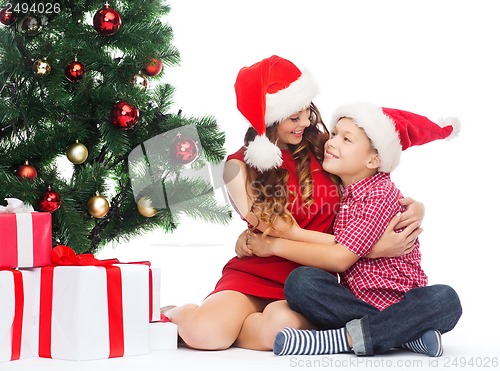 Image of happy mother and child boy with gift boxes