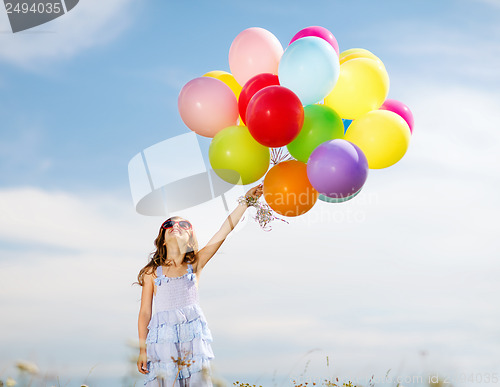 Image of happy girl with colorful balloons