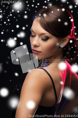 Image of woman in evening dress wearing diamond earrings