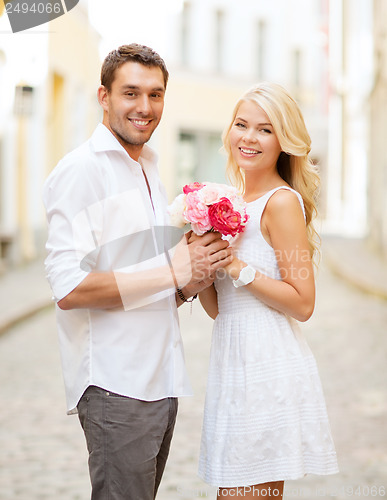 Image of couple with flowers in the city