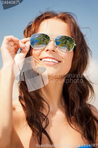 Image of woman in bikini and sunglasses
