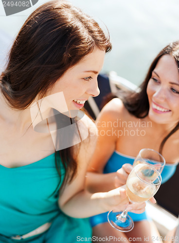 Image of girls with champagne glasses on boat