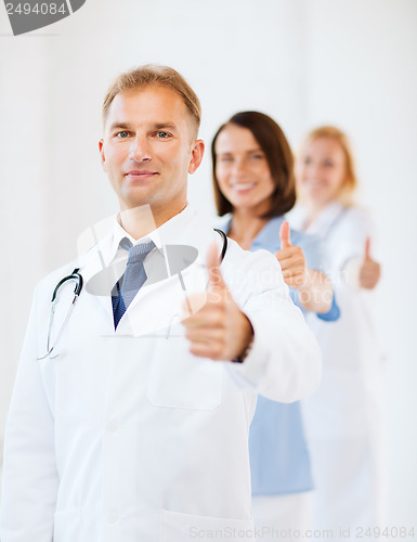 Image of doctor with stethoscope and colleagues