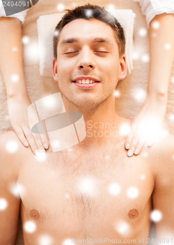 Image of man in spa salon getting massage