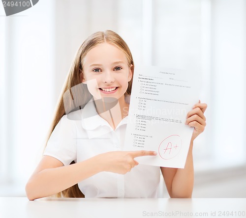 Image of girl with test and grade at school