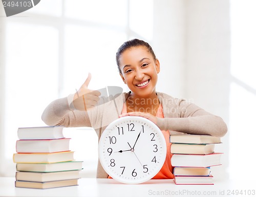 Image of attractive woman with white clock