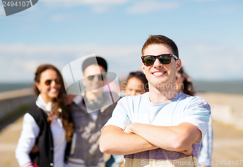 Image of teenager in shades outside with friends