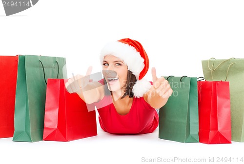 Image of woman in red shirt with shopping bags