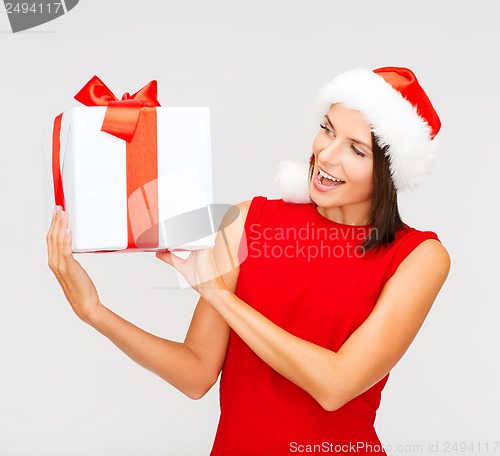 Image of smiling woman in santa helper hat with gift box