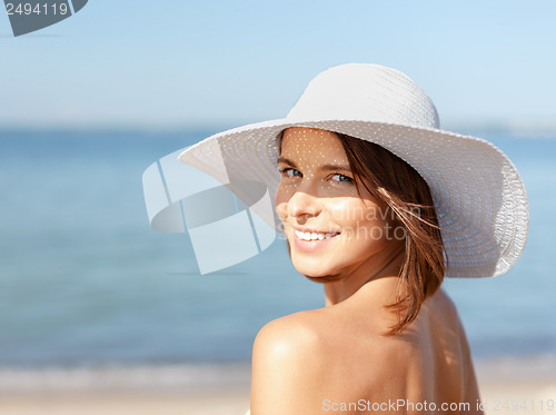 Image of girl in bikini standing on the beach