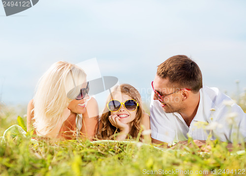 Image of happy family with blue sky and green grass