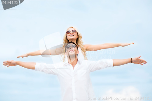 Image of couple holding hands up at sea side