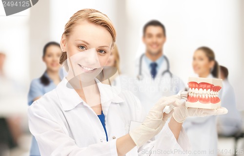 Image of doctor with big jaws and toothbrush