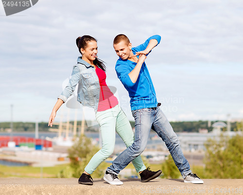 Image of couple of teenagers dancing outside