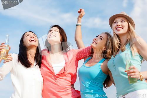 Image of girls with drinks on the beach