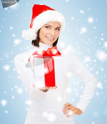 Image of smiling woman in santa helper hat with gift box
