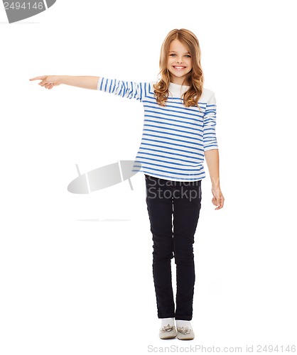 Image of cute little girl pointing to the side