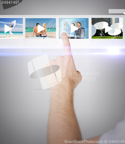 Image of man pressing button on virtual screen