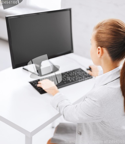 Image of businesswoman with computer in office