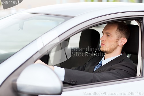 Image of businessman driving a car