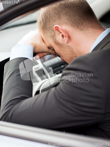 Image of tired businessman or taxi car driver