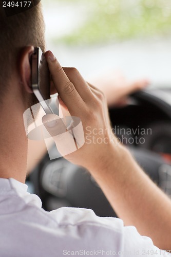 Image of man using phone while driving the car