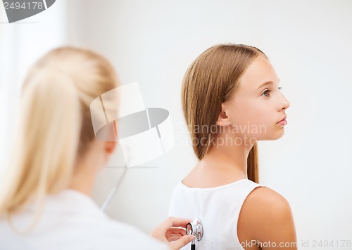 Image of doctor with stethoscope listening to the patient