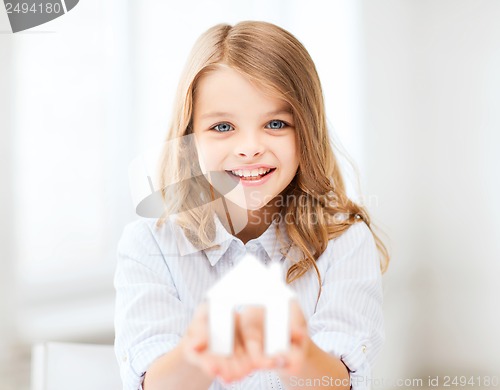 Image of girl holding white paper house
