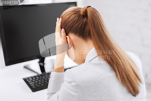 Image of stressed woman with computer