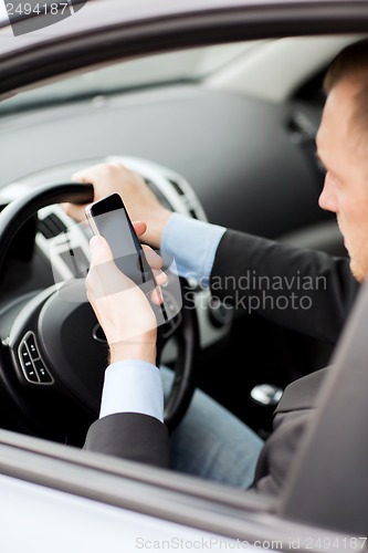 Image of man using phone while driving the car