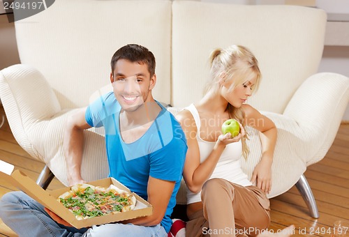 Image of couple eating different food