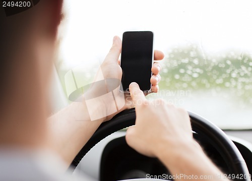 Image of man using phone while driving the car