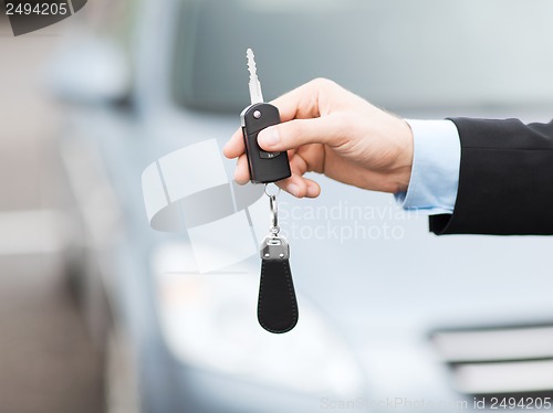 Image of man with car key outside