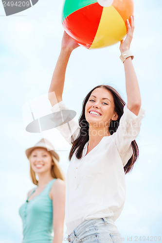 Image of girls playing ball on the beach