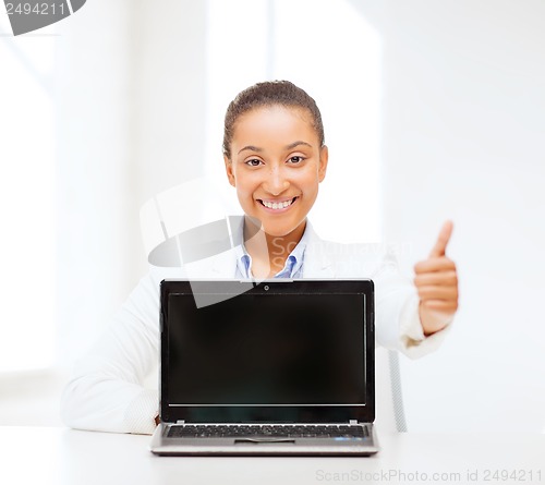 Image of smiling woman with laptop computer