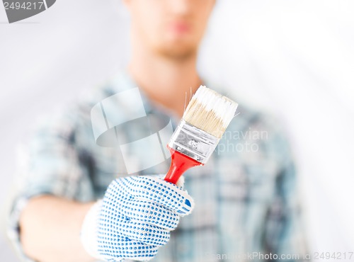 Image of man hand with paintbrush