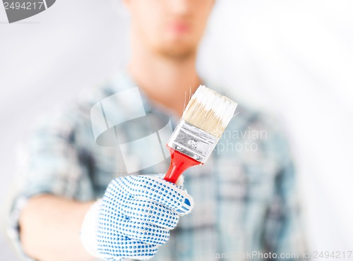 Image of man hand with paintbrush