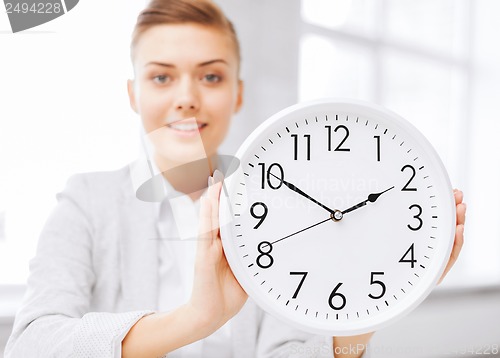 Image of attractive businesswoman with white clock