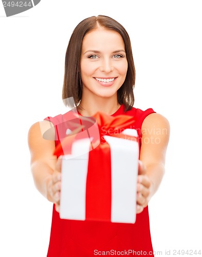Image of smiling woman in red dress with gift box