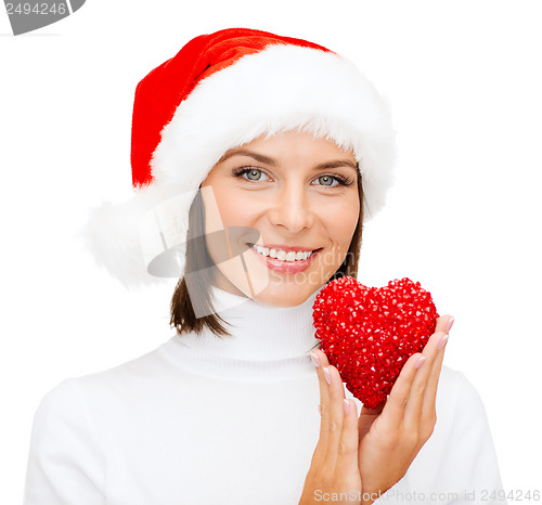 Image of smiling woman in santa helper hat with red heart